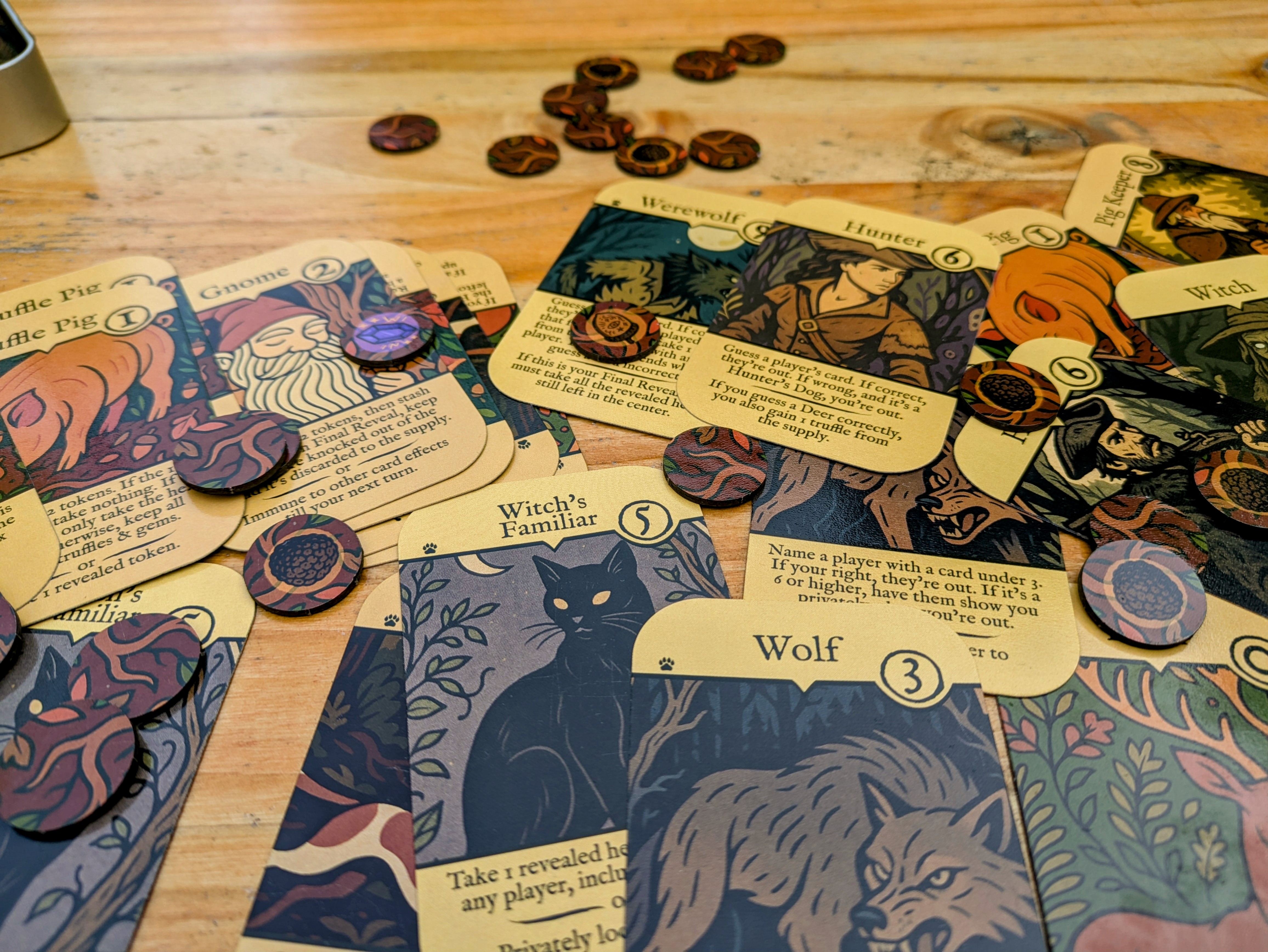Truffle Pigs Card Game components layed out on the table. There are cards and tokens.