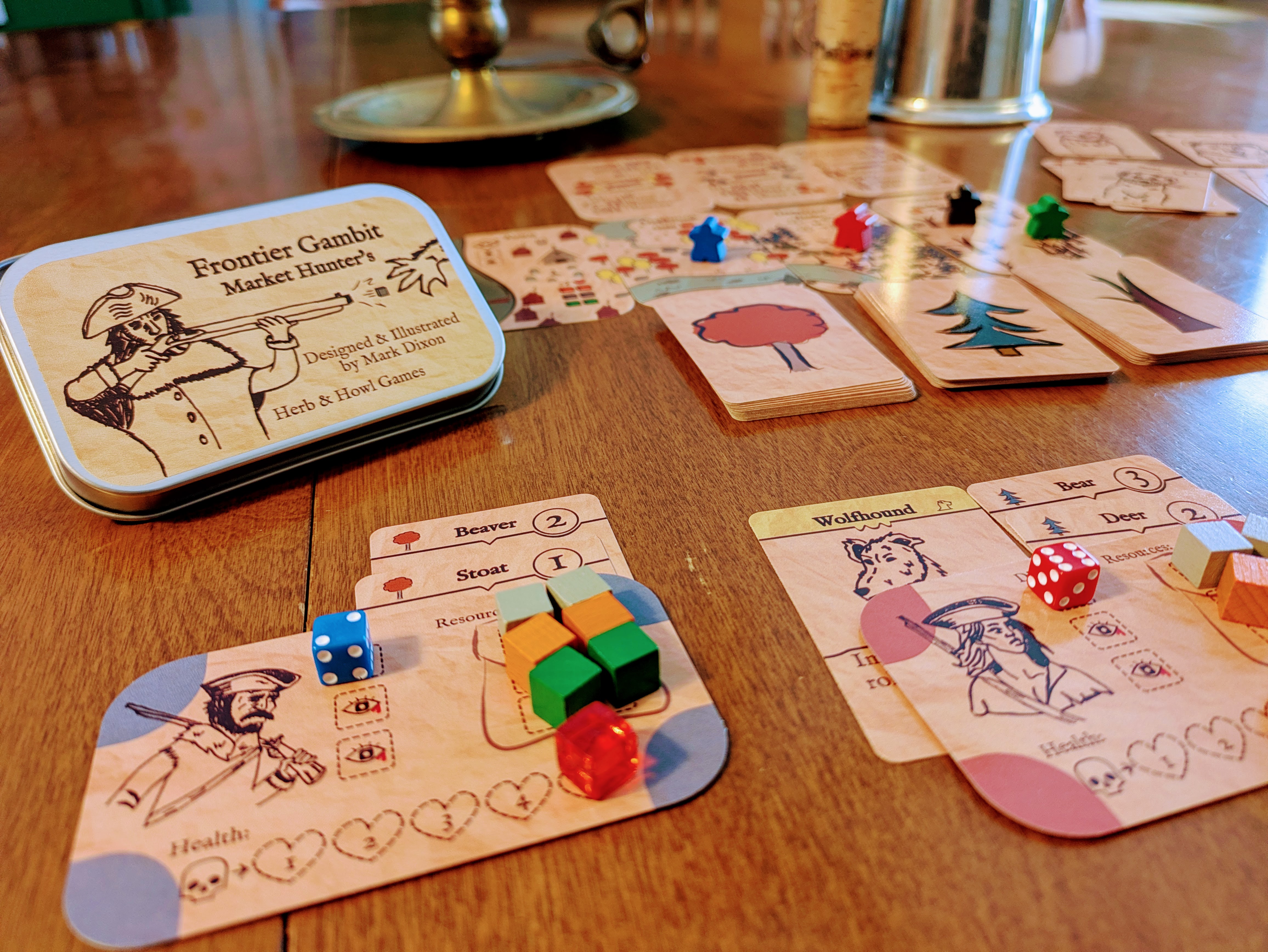 Frontier Gambit Market Hunters boardgame setup on a table.